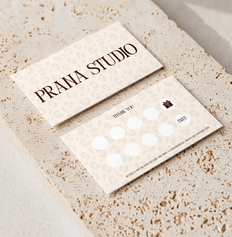 Editable loyalty card template for beauty professionals, Leopard Cream · Gift Reward design, front and back shown on travertine