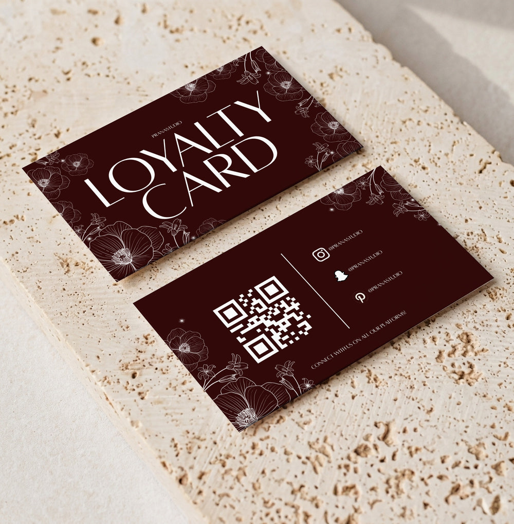 Editable loyalty card template for beauty professionals, Burgundy Floral · QR design, front and back shown on travertine